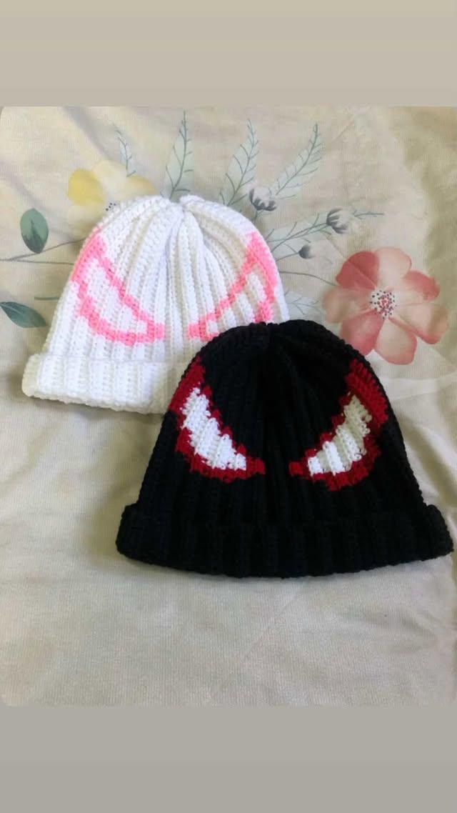 Two crochet beanies, one white and one black