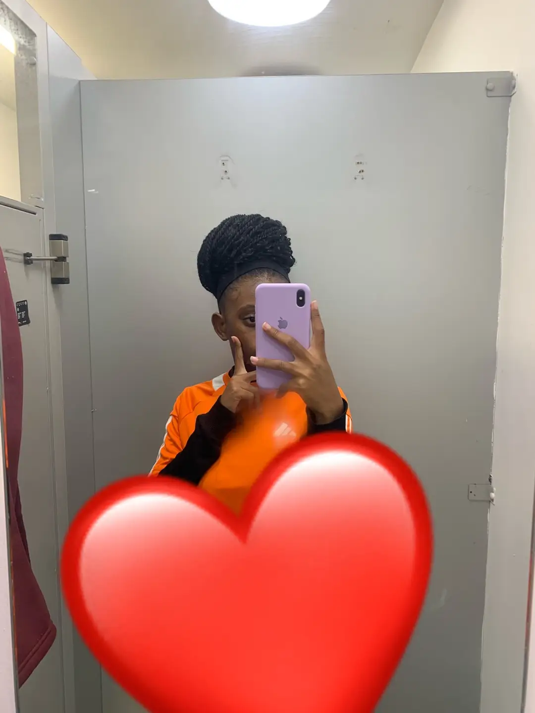 Katie taking a mirror selfie with a heart